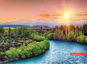 Panoramic view of a forest, a mountain range and a meandering river at sunrise