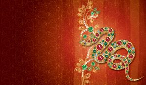 Golden snake inlaid with glittering gemstones on a swirl patterned red gradient