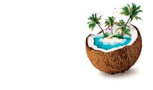 Palm beach island in the center of Blue Hawaiian cocktail inside a coconut cup