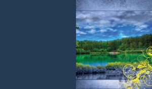 Landscape of a summer lake in the green forest beneath the grey clouds