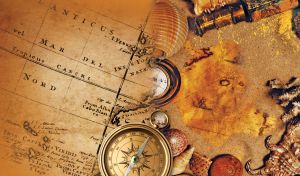 Antique ship's telescope, old golden compass and seashells on an old sepia map