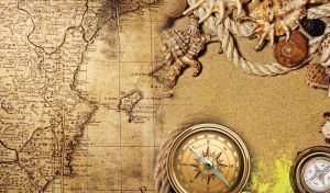 Light brown rope, old golden compass, lambis shells on an old sepia map