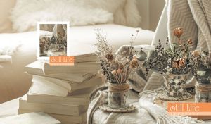 Still life composition of dried flowers and books arranged in soft sepia tones