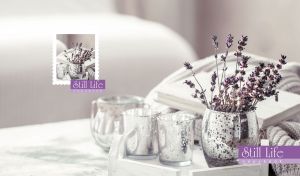 Still life composition of lavenders and glass jars arranged in soft purple tones