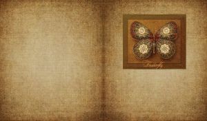 Butterfly with olive green and brown batik wings in a frame on a burlap texture