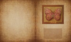 Butterfly with red and golden batik wings in a frame on a burlap texture