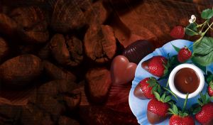 French chocolate-dip strawberry dessert on a light blue plate on a dark brown background