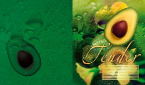 Avocado cut with tender yellow pulp, brown pit and bubbles on a green background