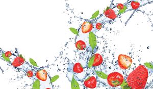 Delicious strawberries fell in the fresh clean water