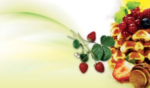 Cranberry and blackberry waffles with maple syrup on a pastel lime backdrop