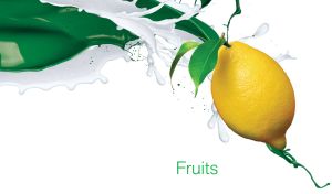 Fresh yellow lemon in the splashes of milk and green liquid on a white backdrop