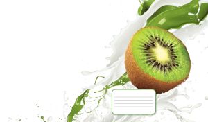 Fresh half kiwi in the splashes of milk and green liquid on a white backdrop