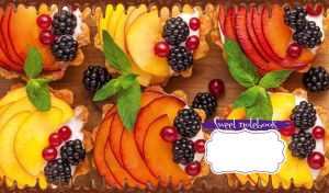 Close-up of mini fruit tarts with berries on a light brown wooden table