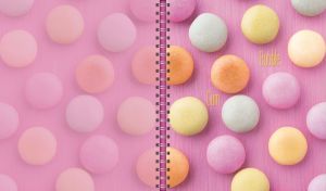 Vivid bubble gums neatly placed on a textured pastel pink backdrop