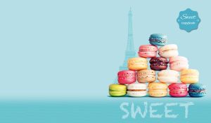 Colorful macaroon pyramid on a teal gradient backdrop