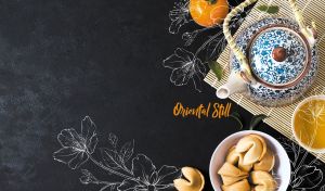 Traditional oriental still life featuring fortune cookies and a tea set on black