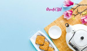 Traditional oriental still life featuring a tea set and flowers on pastel blue