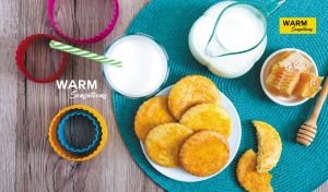 Overhead shot of shortbread cookies arranged on a wood-textured backdrop