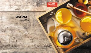 Overhead shot of a lemon tea set arranged on a wood-textured backdrop