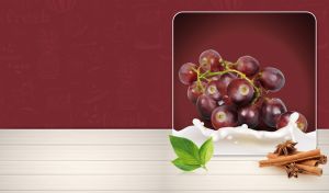 Bunch of grapes with mint and cinnamon sticks isolated against a maroon wallpaper