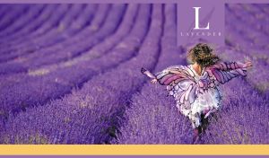 A young woman in a butterfly print dress runs through a purple lavender field