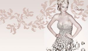 Blonde female model in a christmas ball dress posing against a beige background