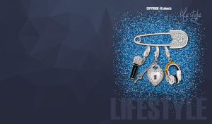 Silver pin amulet against a dark grey backdrop with blue glitter confetti