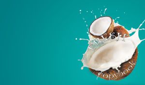 Fresh coconut halves in milk splashes on teal