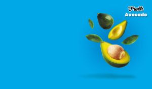 Sliced avocados and green leaves on bright blue