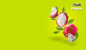 Sliced fresh pitaya fruits and green leaves on bright lime