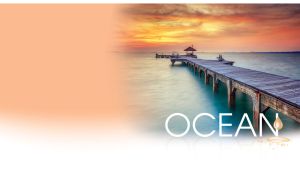 Wooden pier in Thailand waterscape over the misty ocean at a vivid sunrise