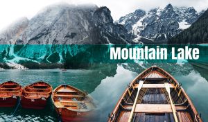 Wooden rowboat on a teal mountain lake against the snow-capped peaks