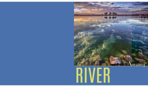 Sunset riverscape with rocks under water with raindrops on glass on blue