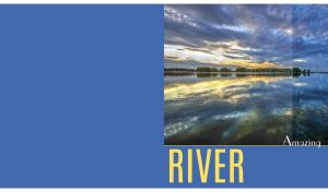 Riverscape with grey cirrus clouds at dawn with raindrops on glass on blue