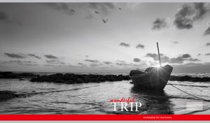 Monochromatic seascape of a moored boat in the sunrise rays