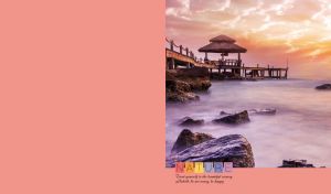 Sea rocks under a gazebo on a wooden pier at sunset on pastel red-pink backdrop