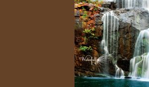Summer waterfall with beautiful gray maroon rocks on a brown background
