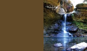 Blue waterfall from huge rocks on a brown background