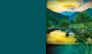 Mountain pasture beneath the yellow sky reflected in the pond waters