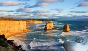 Vertical cliffs in ocher sunrise lights and rocks in the midst of blue the ocean