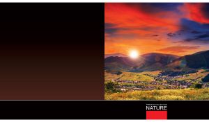 Valley village at dawn against the dark mountain range under red-blue sky