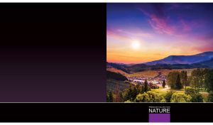 Valley village at dawn against the dark mountain range at purple-blue dawn