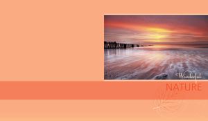 Shallow beach in golden red haze at sunset against a pastel ocher backdrop