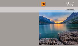 Stone shore of mountain lake at an orange sunset on a gray backdrop