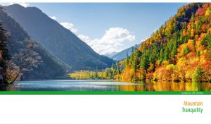 Sunlit mountains with bright autumn forest by the tranquil lake on white