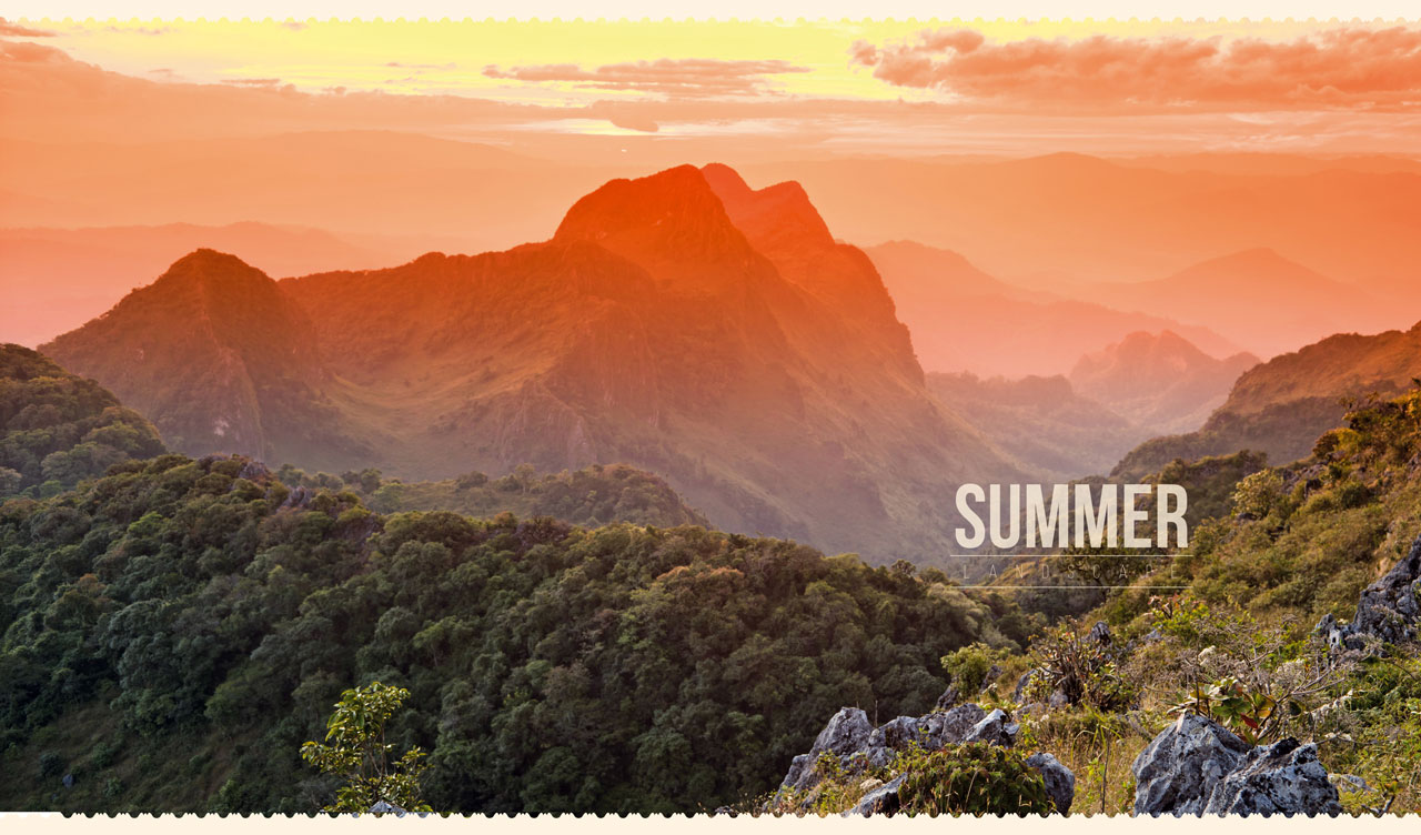 Summer landscape of the silhouettes of orange mountains at sunset