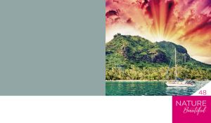 Sailboat by a mountain in the rays of the sunset on a green-grey background