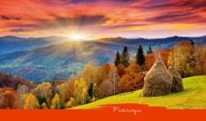 Picturesque view with hay sheaves and an autumn forest at a vivid sunrise