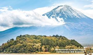 Panoramic view of Fuji mount behind the clouds against a pastel blue sky