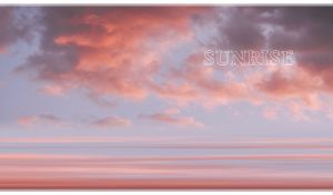 Sunrise seascape with calm sea and purple-pink clouds in a pastel blue sky